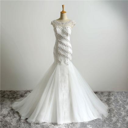 White Floor Length Tulle Mermaid Wedding Gown..