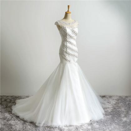 White Floor Length Tulle Mermaid Wedding Gown..